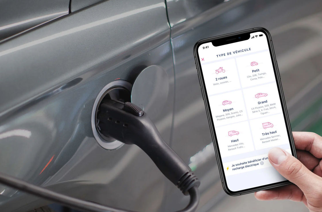 Electric car charging and a smartphone showing the vehicle type selection in the app